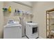 Laundry room features a new washer and dryer, and wire and wood shelving for storage at 1461 Travertine Ter, Sanford, FL 32771