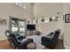 Living room with lots of natural light, plush carpeting, and comfortable leather seating at 1461 Travertine Ter, Sanford, FL 32771