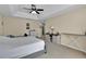 A neutral colored main bedroom with a tray ceiling, ceiling fan, carpet and views of the hallway and bathroom at 1461 Travertine Ter, Sanford, FL 32771