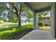 Picturesque backyard view from the covered patio, overlooking the lush lawn and serene pond with a fountain at 1461 Travertine Ter, Sanford, FL 32771