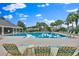 A beautiful community swimming pool surrounded by lounge chairs and lush landscaping at 1461 Travertine Ter, Sanford, FL 32771