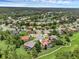 Aerial view of neighborhood featuring lake, lush landscaping, and mature trees at 1462 Palm Bay Ct, Lake Mary, FL 32746