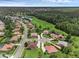 Aerial view of neighborhood featuring lake, lush landscaping, and mature trees at 1462 Palm Bay Ct, Lake Mary, FL 32746