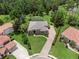 Aerial view of home with screened in pool, brick driveway, and lush landscaping at 1462 Palm Bay Ct, Lake Mary, FL 32746
