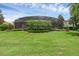 Manicured backyard with privacy landscaping and screened pool at 1462 Palm Bay Ct, Lake Mary, FL 32746