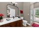 Modern bathroom with dark brown vanity, white quartz countertop, walk-in shower and black hardware fixtures at 1462 Palm Bay Ct, Lake Mary, FL 32746