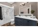 Bathroom with a modern vanity, marble countertops, and decorative floral shower curtain at 1462 Palm Bay Ct, Lake Mary, FL 32746
