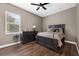 Cozy bedroom features a dark wood dresser, natural light, and ceiling fan at 1462 Palm Bay Ct, Lake Mary, FL 32746