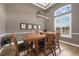 Formal dining room with modern light fixture and large window bringing in natural light at 1462 Palm Bay Ct, Lake Mary, FL 32746
