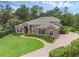 Exterior of house with well manicured lawn and brick driveway at 1462 Palm Bay Ct, Lake Mary, FL 32746