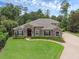 Stunning single-story home with lush landscaping and a paver driveway at 1462 Palm Bay Ct, Lake Mary, FL 32746