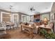 Open-concept living room with a dining nook, wood floors, ceiling fan, and sliding glass doors to a patio at 1462 Palm Bay Ct, Lake Mary, FL 32746