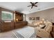 Cozy living room with custom built-ins, reclining sofa, wood floors, and a ceiling fan at 1462 Palm Bay Ct, Lake Mary, FL 32746