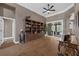 Open-concept living area with built-in shelving, wood floors, and outdoor access at 1462 Palm Bay Ct, Lake Mary, FL 32746
