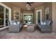 Cozy outdoor living space with brick flooring, comfortable seating and sliding doors for seamless indoor/outdoor flow at 1462 Palm Bay Ct, Lake Mary, FL 32746