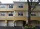 Attractive townhome featuring white trim, a red front door and a convenient drive-in garage at 1960 Legacy Cove Dr, Maitland, FL 32751