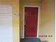 Close-up of the red front door with a unit number next to the drive-in garage at 1960 Legacy Cove Dr, Maitland, FL 32751