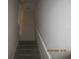 Carpeted staircase with white railing at 1960 Legacy Cove Dr, Maitland, FL 32751