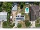 Aerial view of property featuring home with solar panels, detached garage, inground pool and fenced yard at 1963 Forest Ave, Daytona Beach, FL 32119