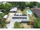 Aerial view of property featuring a pool, large detached garage, solar panels and ample yard space at 1963 Forest Ave, Daytona Beach, FL 32119