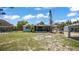 Large backyard featuring grass area, detached garage, and screened in porch at 1963 Forest Ave, Daytona Beach, FL 32119