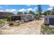 Backyard with propane tanks, central air, shed, and screened in patio area at 1963 Forest Ave, Daytona Beach, FL 32119