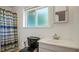 Well-lit bathroom featuring a modern vanity, a sleek toilet, and a stylish striped shower curtain at 1963 Forest Ave, Daytona Beach, FL 32119