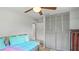 Bedroom featuring a pull-out bed, closet with louvered doors, and neutral decor at 1963 Forest Ave, Daytona Beach, FL 32119
