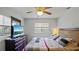 Bedroom with a ceiling fan, dark wood furniture, neutral walls, and plenty of natural light at 1963 Forest Ave, Daytona Beach, FL 32119