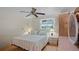 Cozy bedroom with a ceiling fan, ample natural light, and minimalist decor, creating a serene atmosphere at 1963 Forest Ave, Daytona Beach, FL 32119