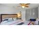 Cozy bedroom featuring a ceiling fan, closet with louvered doors, and soft neutral tones at 1963 Forest Ave, Daytona Beach, FL 32119