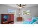 Bright bedroom featuring two windows, a ceiling fan, tile floors, and neutral walls at 1963 Forest Ave, Daytona Beach, FL 32119