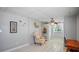 Spacious bonus room with a comfortable chair, shelving, a writing desk and tile flooring at 1963 Forest Ave, Daytona Beach, FL 32119