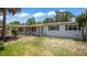 Inviting single-story home enhanced by a carport, complemented by a well-manicured front yard at 1963 Forest Ave, Daytona Beach, FL 32119