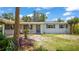 Delightful single-story home boasts a welcoming front porch and beautifully maintained landscaping at 1963 Forest Ave, Daytona Beach, FL 32119