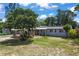 Charming single-story home with blue shutters and lush landscaping, perfect for curb appeal at 1963 Forest Ave, Daytona Beach, FL 32119
