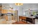 Bright kitchen features light cabinets, stainless appliances, and adjacent dining area with wood table at 1963 Forest Ave, Daytona Beach, FL 32119