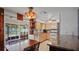 Traditional kitchen with wood cabinets, tile floors, stainless appliances, and view to outdoor patio at 1963 Forest Ave, Daytona Beach, FL 32119