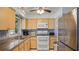 Well-lit kitchen with light wood cabinets, stainless steel appliances and tile backsplash at 1963 Forest Ave, Daytona Beach, FL 32119