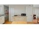 The modern kitchenette is equipped with white cabinets, a microwave, and a countertop, and offers ample storage at 1963 Forest Ave, Daytona Beach, FL 32119