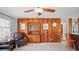 Inviting living room featuring a built-in cabinet, tile flooring, and rustic wood accent wall at 1963 Forest Ave, Daytona Beach, FL 32119