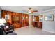 Cozy living room boasts wood paneling, tile flooring, and a charming built-in cabinet for storage at 1963 Forest Ave, Daytona Beach, FL 32119