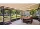 Enclosed patio with view of yard and pool featuring a dining table and ceiling fan at 1963 Forest Ave, Daytona Beach, FL 32119