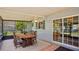 View of the enclosed patio from a different angle, showing the dining table and sliding door at 1963 Forest Ave, Daytona Beach, FL 32119