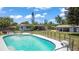 Fenced in in-ground pool with chairs and lush backyard at 1963 Forest Ave, Daytona Beach, FL 32119