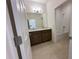 Bathroom with double vanity, tiled floors, and shower-tub combo with white tiled surround at 2043 Town Pasture Dr, Eustis, FL 32726