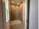 Shower with glass door and a rain shower head in a modern, tiled bathroom at 2043 Town Pasture Dr, Eustis, FL 32726
