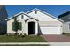 Charming single-story home with a two-car garage and a well-manicured front yard at 2043 Town Pasture Dr, Eustis, FL 32726
