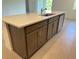 Kitchen island with quartz countertop, modern cabinets, and stainless steel dishwasher at 2043 Town Pasture Dr, Eustis, FL 32726