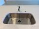 Close up of the kitchen sink with a stainless steel faucet and white countertop at 2043 Town Pasture Dr, Eustis, FL 32726